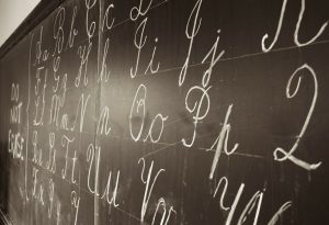 Cursive letters on blackboard.