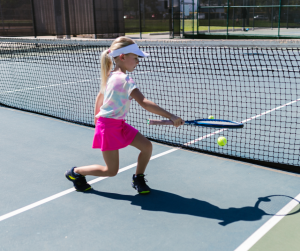 little girl playing tennis